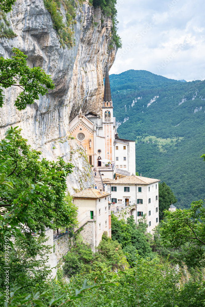 Magnificent view of the Madonna della Corona sanctuary: a monastery and church on a steep vertical cliff near the village of Spiazzi in the southern Italian Alps Magnificent view of the Madonna della Corona sanctuary: a monastery and church on a steep vertical cliff near the village of Spiazzi in the southern Italian Alps