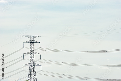 Electric poles and lines or high voltage towers at beautiful sky