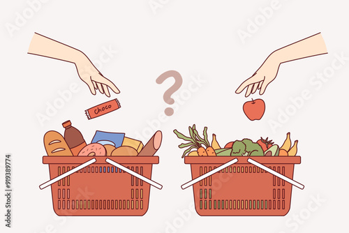 Carts with purchases from grocery supermarket, for concept choosing between healthy eating and junk food. Question is what to buy at grocery store - high-calorie snacks or vegetables and fruits