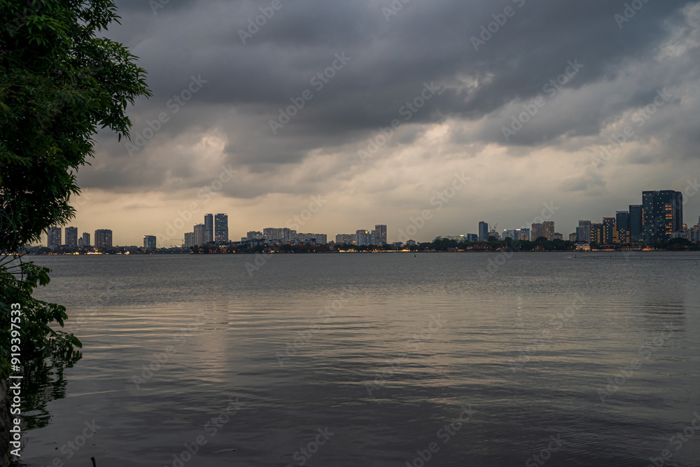 West Lake in Hanoi in the dark cloudy evening. Ha Noi cityscape. Travel concept West Lake in Hanoi in the dark cloudy evening. Ha Noi cityscape. Travel concept