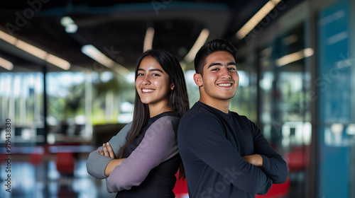 portrait of a couple of happy smiling hispanic latinos college students posing back to back