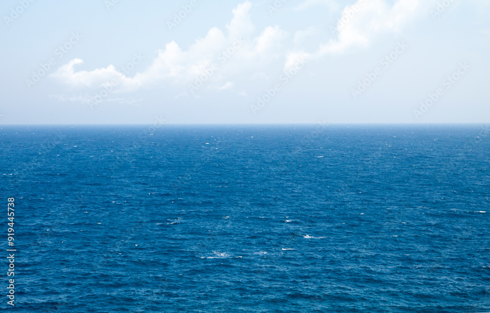 Fototapeta premium Sea to the horizon and blue sky with clouds. Greece, Mediterranean Sea.