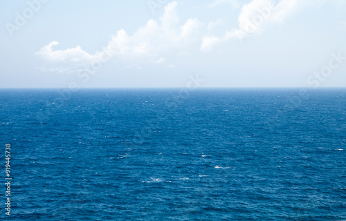 Sea to the horizon and blue sky with clouds. Greece, Mediterranean Sea.