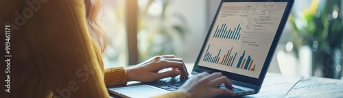 A businesswoman reviewing a performance dashboard on her laptop, with graphs showing key performance indicators, professional, insightful