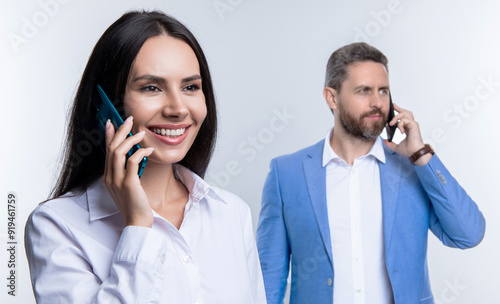 Phone call to colleague. Businesspeople talking on phone isolated on white. Businesspeople using phone for conversation. Business communication in office. Business negotiation call. Selective focus