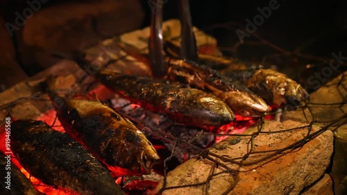 Selective focus of Grilling Cakalang fish or Skipjack tuna (Katsuwonus pelamis) on a cast iron grill. close up view photo