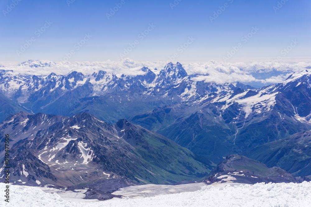 Obraz premium mountain landscape, view from highland snow slope to green valleys, view from Mount Elbrus to the Main Caucasian Range