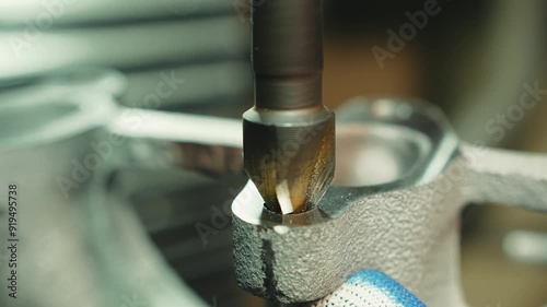 Macro shot of high hardness diamond coated beet drilling and expands the hole in a metal surface 