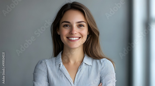 A closeup photo of a woman, age 30 wearing business attire, smiling and posing against a alight background photo