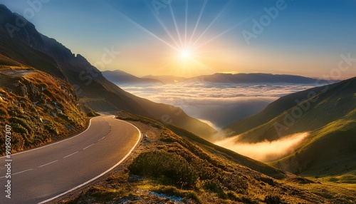winding mountain road at dawn mistshrouded valleys below sun breaking through clouds symbolizing journey and new beginnings photo