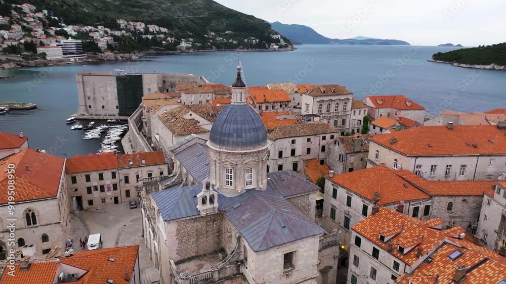 Amazing panoramic video of picturesque Dubrovnik old town, towers, narrow stone streets and buildings with red roofs on Adriatic sea coast, Croatia.