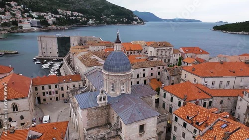 Amazing panoramic video of picturesque Dubrovnik old town, towers, narrow stone streets and buildings with red roofs on Adriatic sea coast, Croatia.