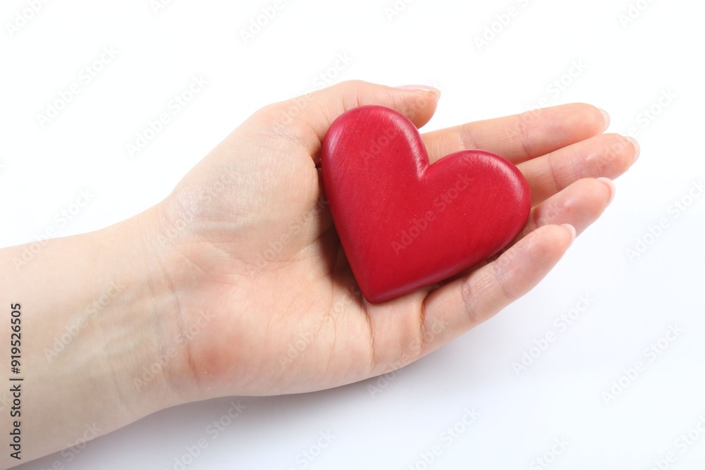 Woman holding red heart on white background, closeup
