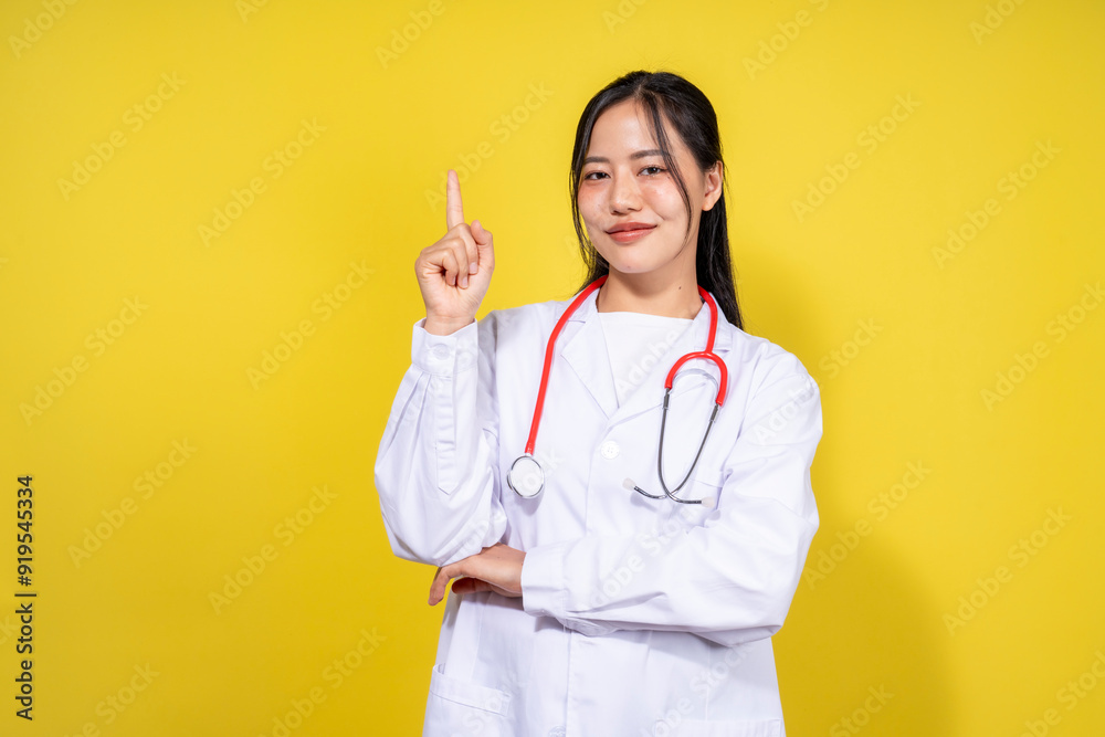 A woman in a white lab coat is pointing to the sky with her finger