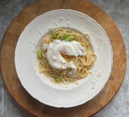 Spaghetti in a bowl topped with an egg