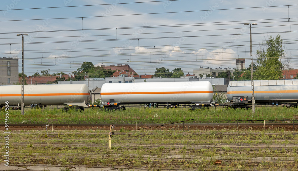 Gas tanker cargo wagon, freight train, gas tanks on the railway, railroad, side view, gas fuel transportation, industrial fuel oil transport, dangerous flammable materials, gas crisis concept, nobody Gas tanker cargo wagon, freight train, gas tanks on the railway, railroad, side view, gas fuel transportation, industrial fuel oil transport, dangerous flammable materials, gas crisis concept, nobody