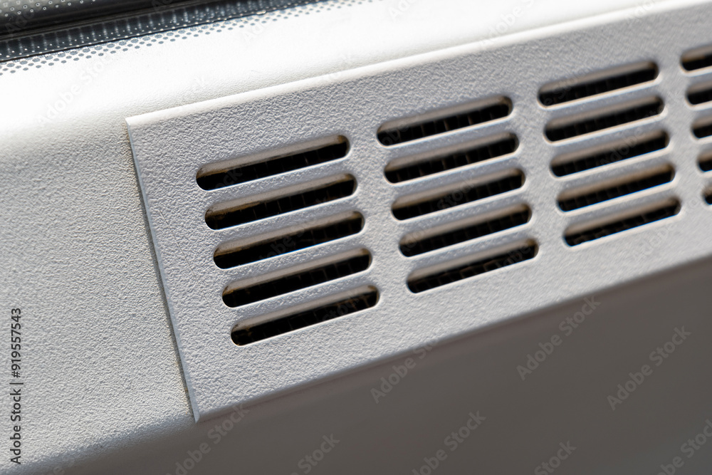 Simple clean metal air vent, air conditioning outlet holes, public transport vehicle train bus metro or industrial air duct part detail closeup, nobody. Cleaning, servicing AC systems simple concept Simple clean metal air vent, air conditioning outlet holes, public transport vehicle train bus metro or industrial air duct part detail closeup, nobody. Cleaning, servicing AC systems simple concept