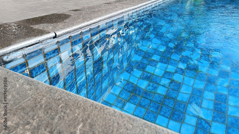 A pool with a blue tile border A pool with a blue tile border