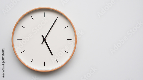 Minimalist wooden Wall Clock on White Wooden Surface with Space for Text – Time Set at 17.05/05.05