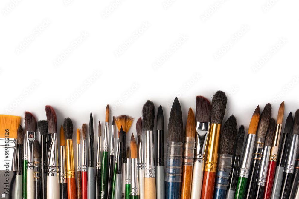 Mix of paint brushes in a row isolated on a white background. Mix of paint brushes in a row isolated on a white background.