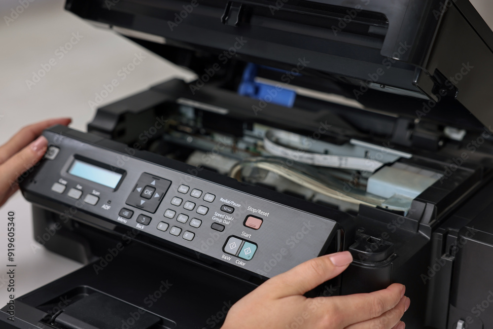 Woman using modern printer at workplace indoors, closeup Woman using modern printer at workplace indoors, closeup