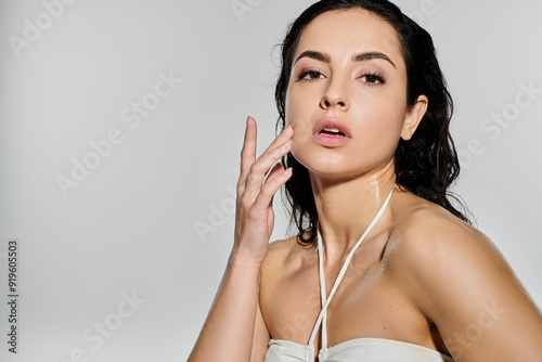 Beautiful woman demonstrates her skin care routine with a vibrant backdrop.