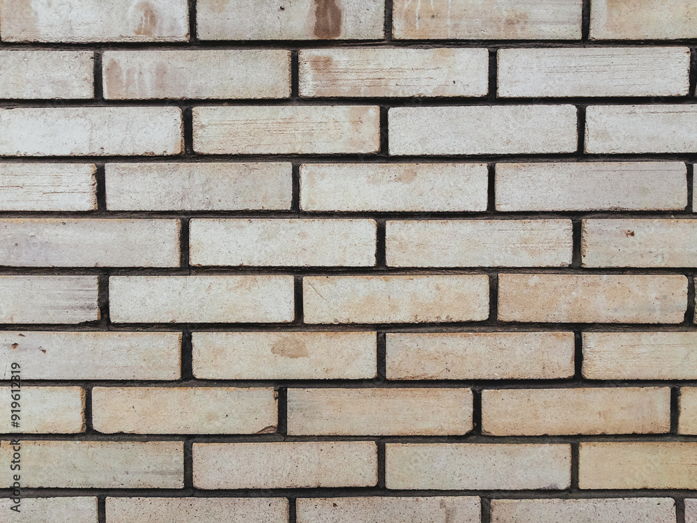 A brick wall with a white brick pattern A brick wall with a white brick pattern