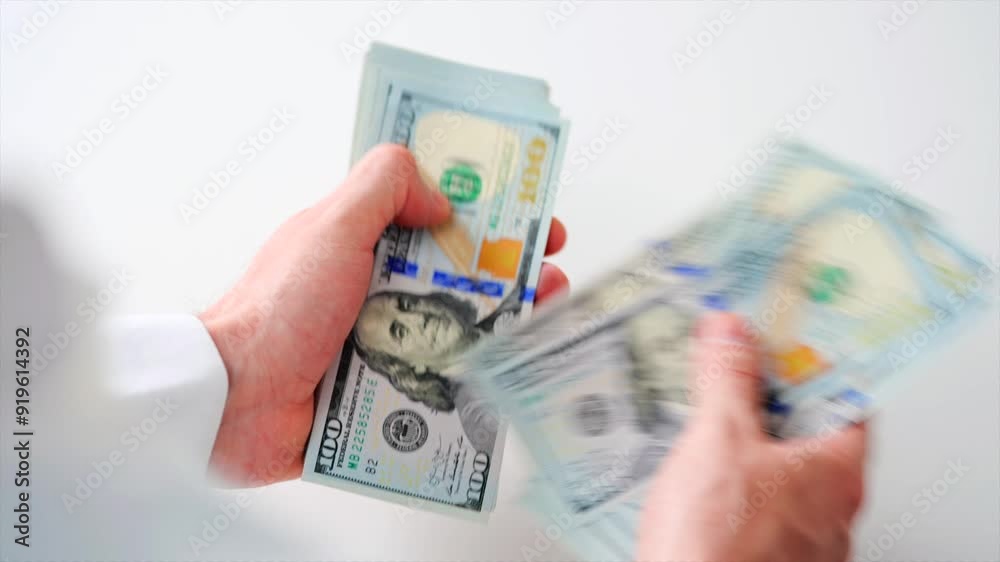 Male hands counting US Dollar bills, close-up Male hands counting US Dollar bills, close-up