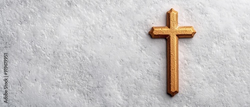  A tight shot of a weathered wooden cross against a pristine white concrete backdrop, displaying a minor fissure running through its center