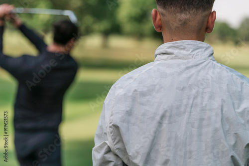 two people playing golf