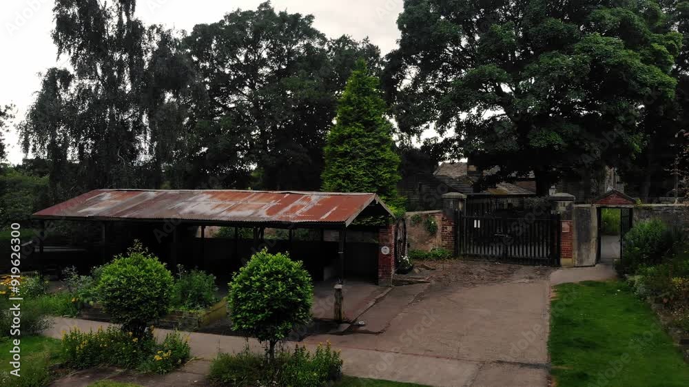 Rusty old shed in English garden in public park wide aerial drone Rusty old shed in English garden in public park wide aerial drone