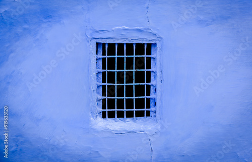 black window in a blue wall 