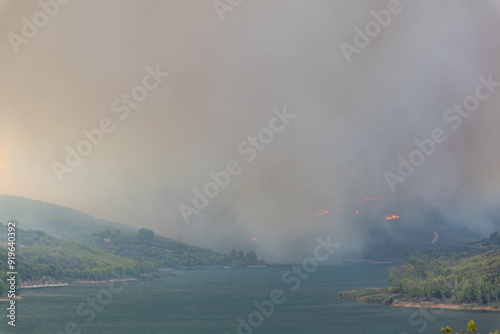 Smoke on a forest fire next to the lake