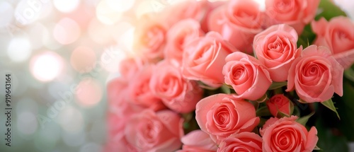  A white countertop holds a bouquet of pink roses before a green leafy plant