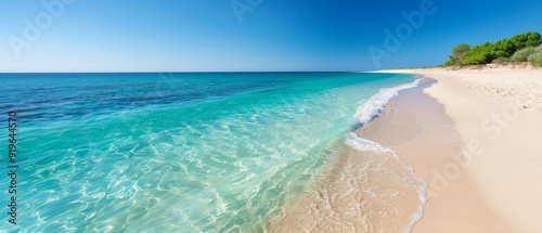 Obraz na płótnie A bird's-eye perspective of a sandy shoreline boasting clear blue water and pristine white sand, all beneath a vast, clear blue sky w salonie