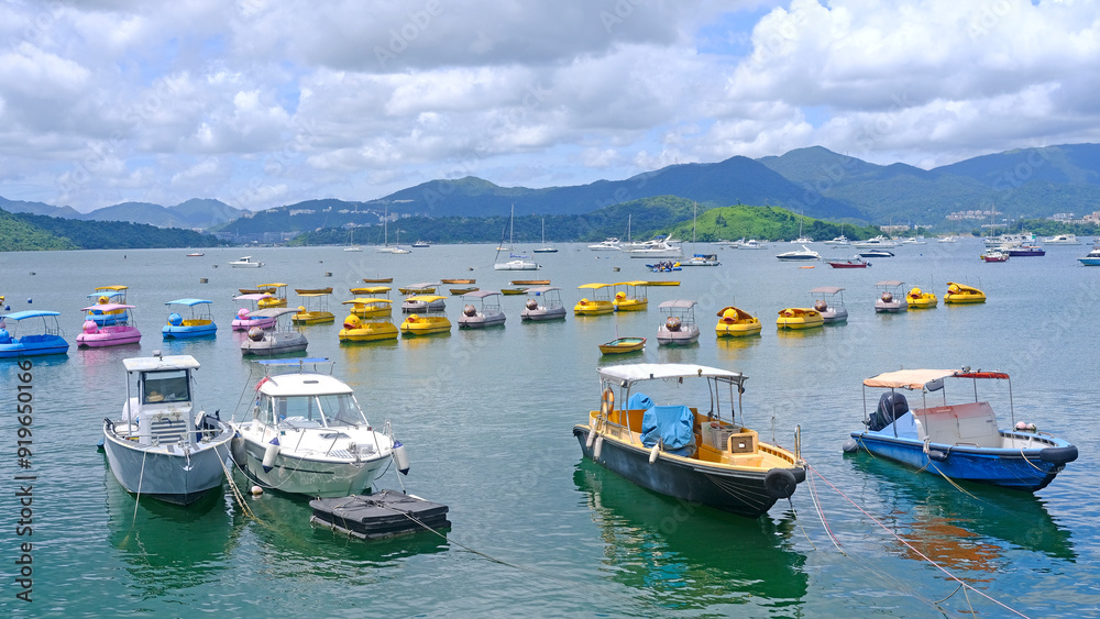 White and yellow recreational outdoor boats, mountain, lake and sky White and yellow recreational outdoor boats, mountain, lake and sky