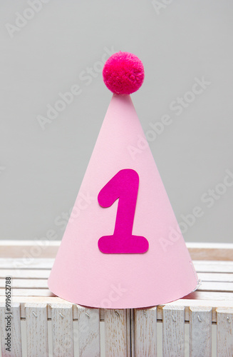 pink cardboard hat with pompom for birthday 1 year old