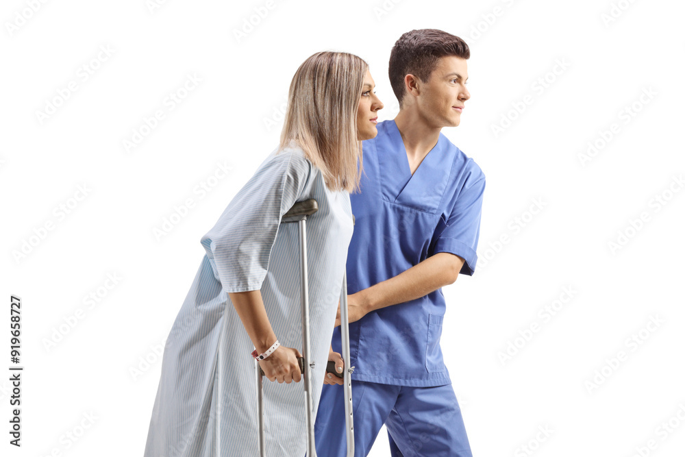 Health care worker helping a female patient with crutches Health care worker helping a female patient with crutches