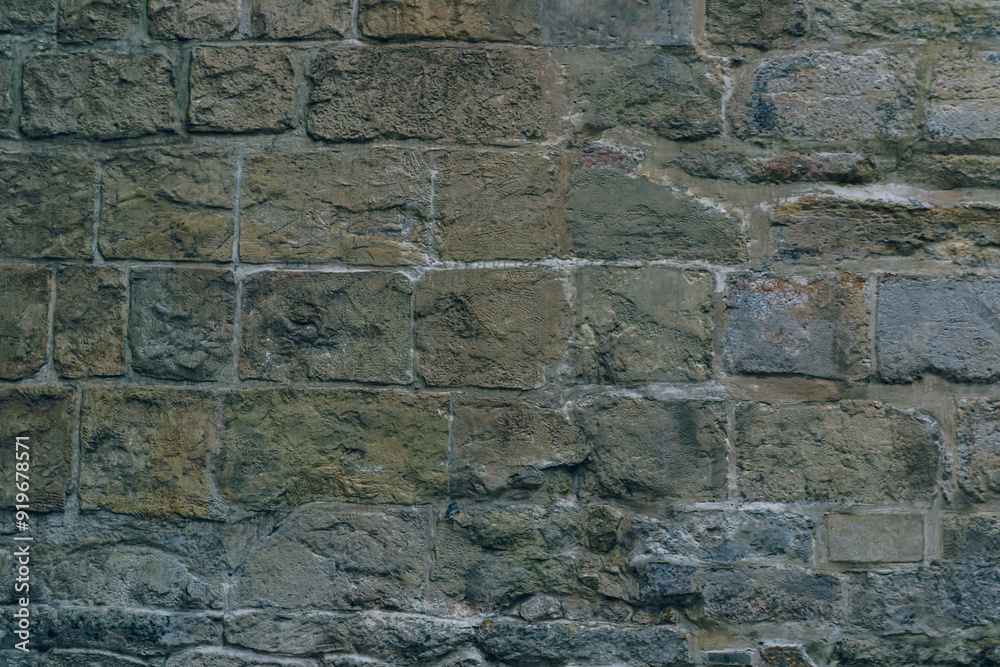 Fototapeta premium A wall made of stone bricks with a rough texture