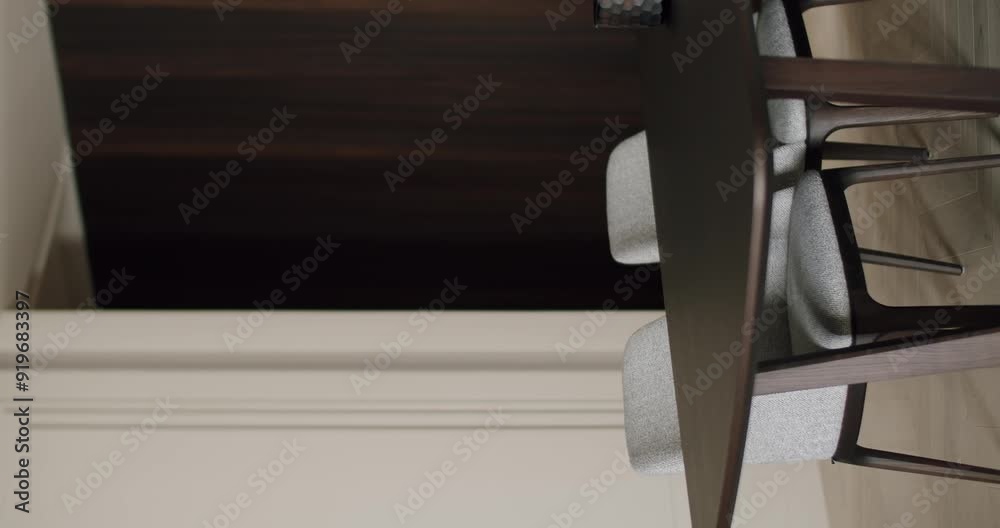 A modern minimalist dining table and chairs set in a stylish, contemporary interior with clean lines and sophisticated design. Ideal for dining room inspiration and modern decor ideas. Vertical A modern minimalist dining table and chairs set in a stylish, contemporary interior with clean lines and sophisticated design. Ideal for dining room inspiration and modern decor ideas. Vertical