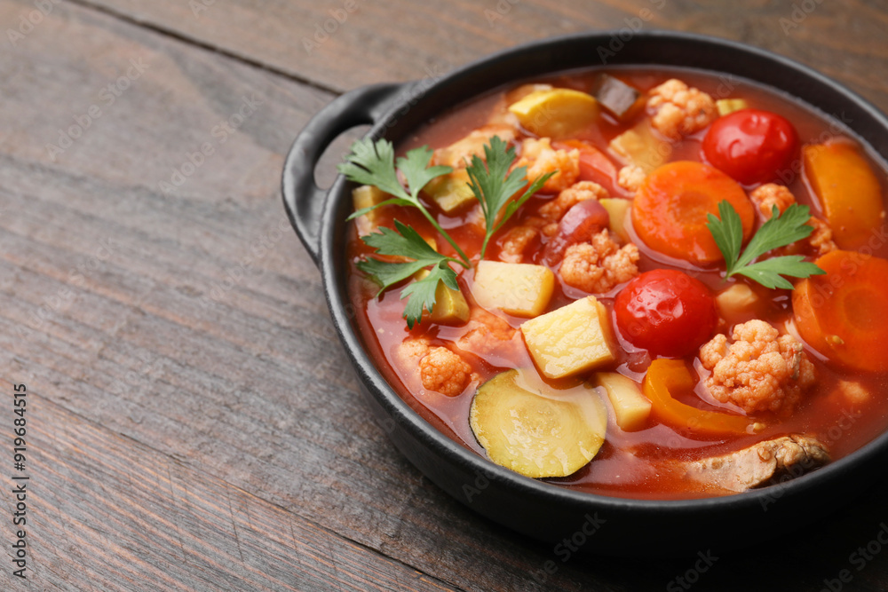 Tasty homemade stew with vegetables on wooden table, closeup. Space for text Tasty homemade stew with vegetables on wooden table, closeup. Space for text