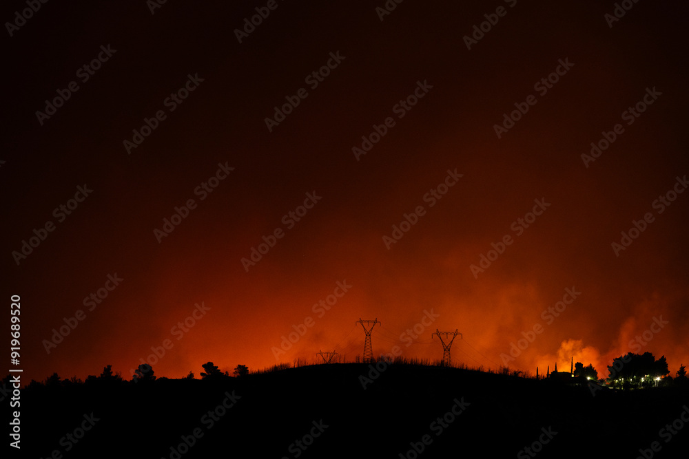 Glow from a forest fire at night