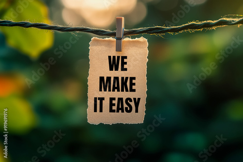 We make it easy message written on paper hung with clothespins. Conceptual we make it easy symbol. Copy space.