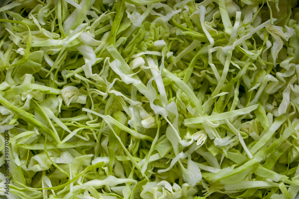 Shredded white cabbage. Background of sliced fresh white cabbage. Vegetarian food. Shredded white cabbage. Background of sliced fresh white cabbage. Vegetarian food.