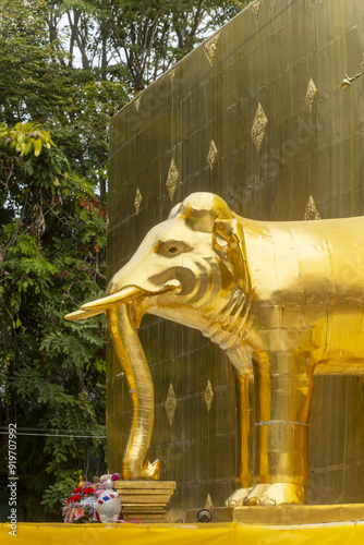 gold covered elephant emerging from the base of the Chedi PhraThatLuang in the Wat Phra Singh Temple in Chiang Mai, Thailand photo