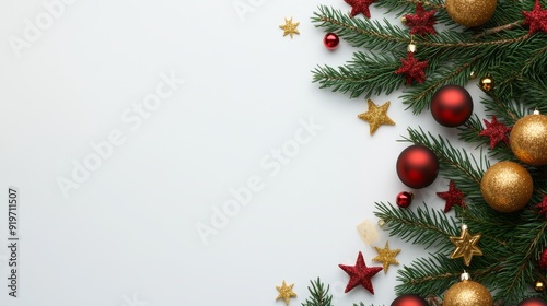 Stunning Christmas flat lay composition showcasing fir branches embellished with golden and red stars and balls, creating a vibrant and festive scene against a crisp white background. The top view