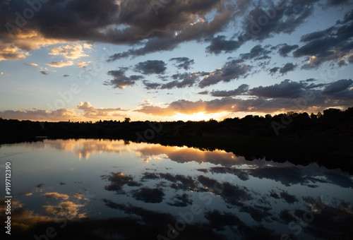 Stunning scenic sunset over lake with clouds and silhouette, Utah