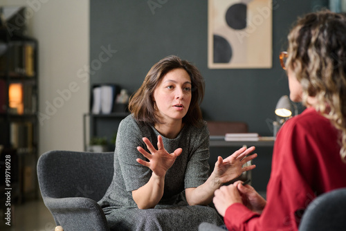 Принти на полотні Engaged in deeply meaningful discussion during a therapy session in a cozy and c