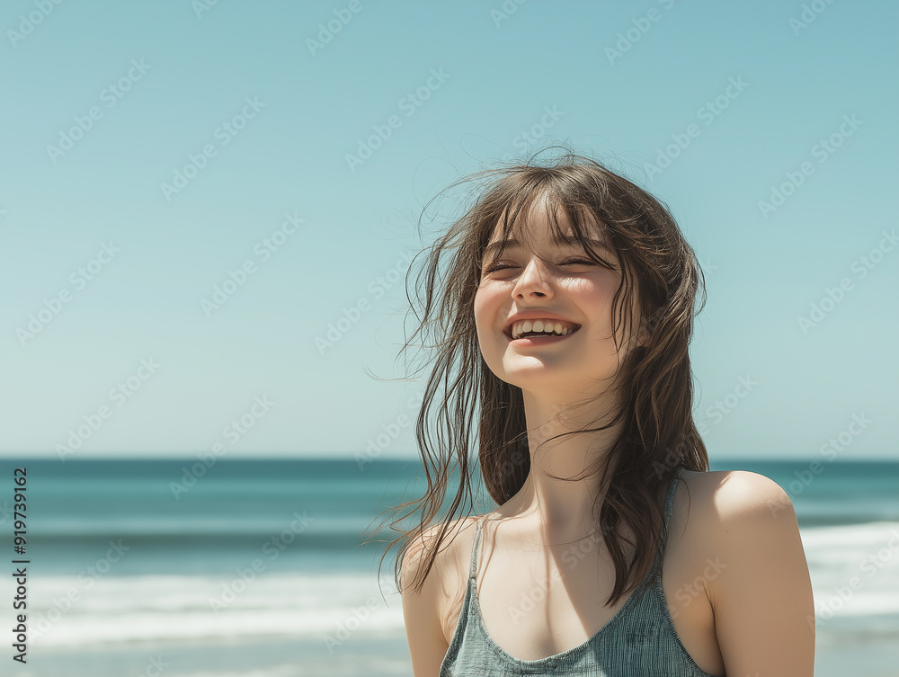 A young woman with windswept hair smiling at the beach, under a clear blue sky, representing carefree summer joy and natural beauty. A young woman with windswept hair smiling at the beach, under a clear blue sky, representing carefree summer joy and natural beauty.