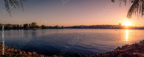 Panoramic view of Saint Roque Lake in Villa Carlos Paz at sunset while people enjoy rowing